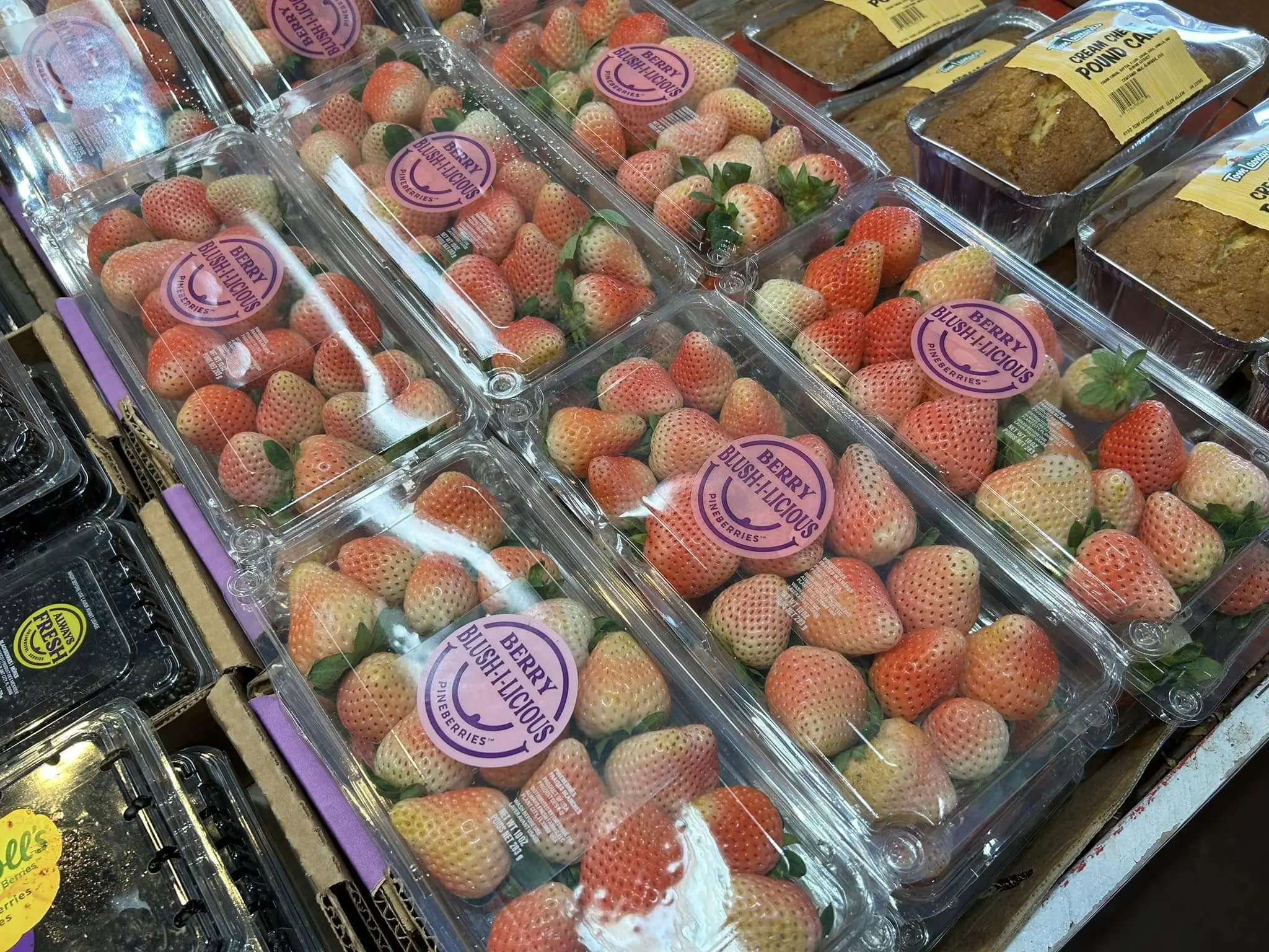 A photo of pineberries displayed at a farmer’s market or grocery store