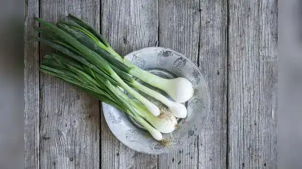 Green Garlic On A Wooden Table